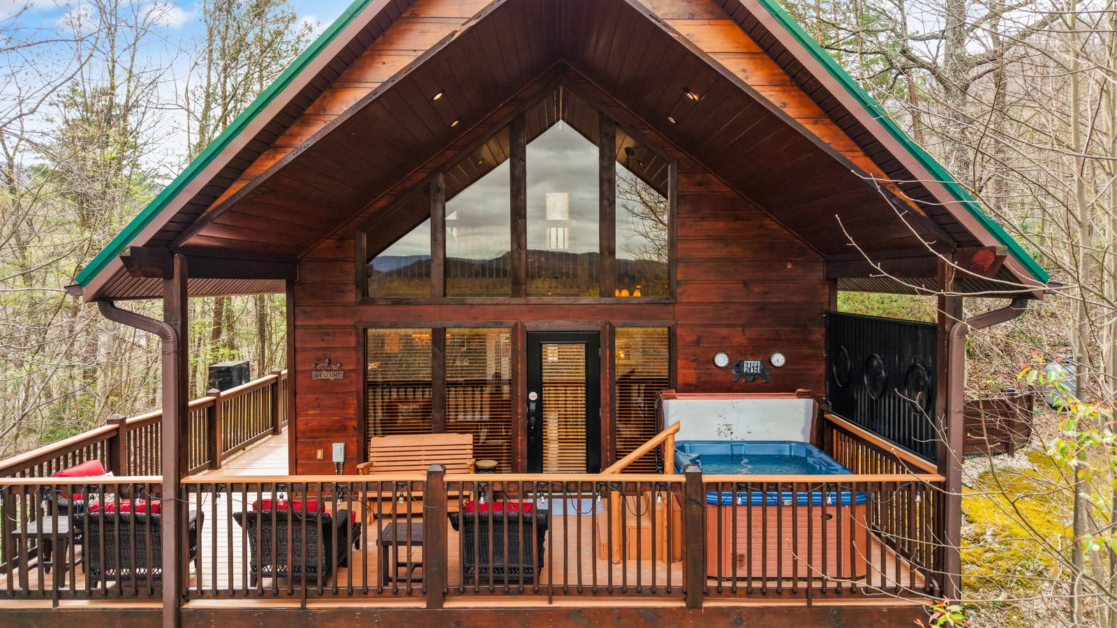 Golden Ridge cabin exterior with wrap-around deck and hot tub