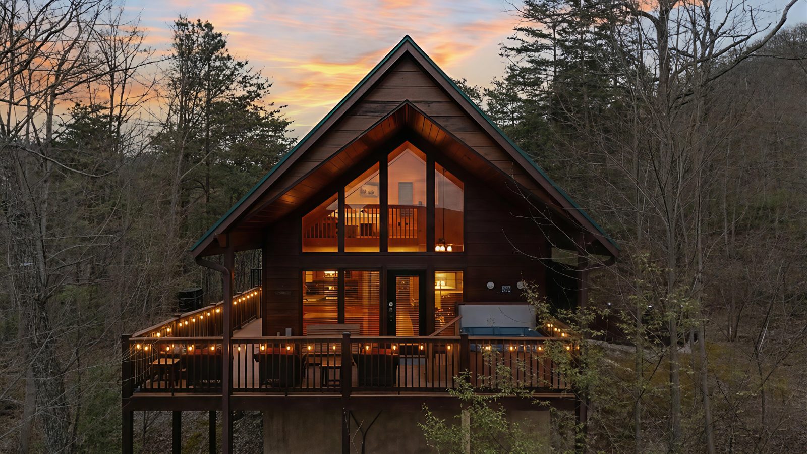 Deck lights and lit windows as the sky turns at dusk